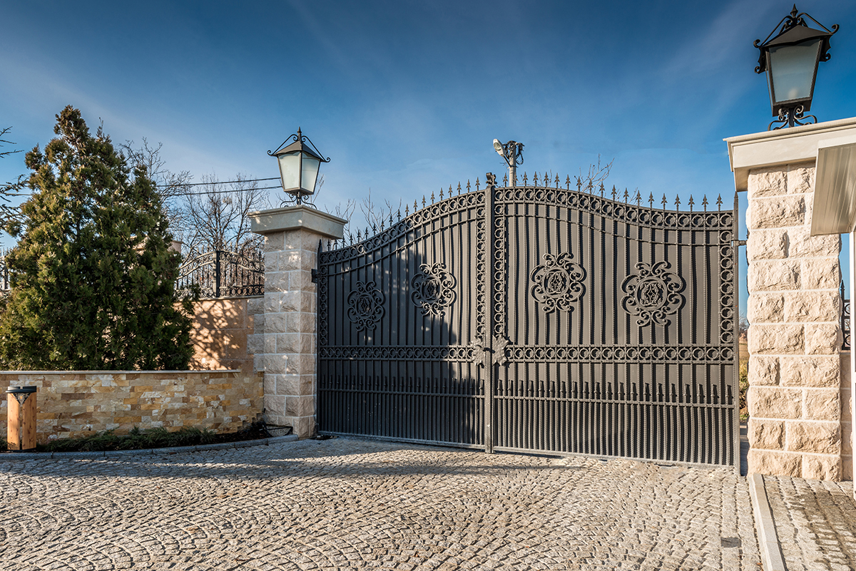 Metal driveway security entrance gates set in brick fence - Double R ...